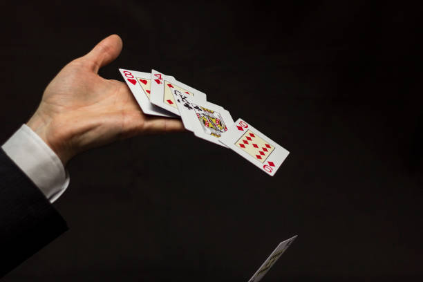 istock Man in suit with playing cards 937843498