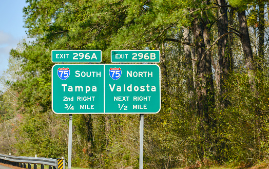 Signs on an interstate in Florida point the way on a road trip.