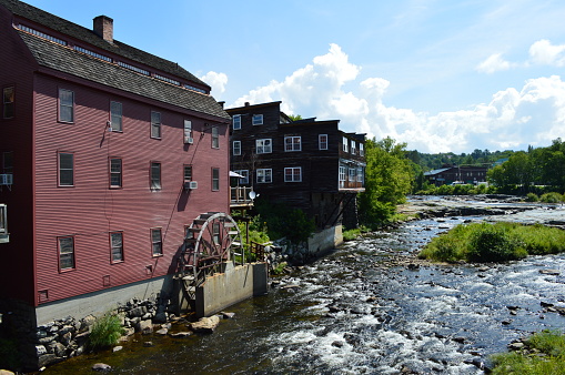 A view of Littleton New Hampshire along the Ammonoosuc with the old mill and water wheel.