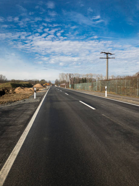 istock Rural scene of a road with blue cloudy sky 937852400
