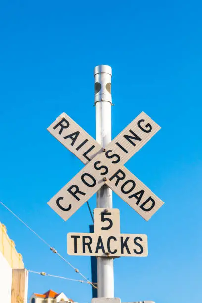 railroad crossing sign with blue sky