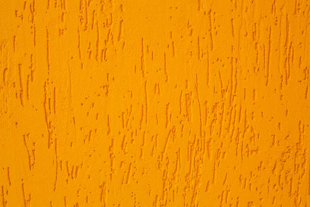 istock close-up pastel yellow concrete wall texture background 937855450