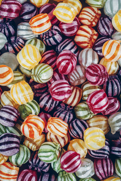 istock A pile of tiny multi-coloured candy sweets. Bad teeth or obesity concept. View from above. 937860404