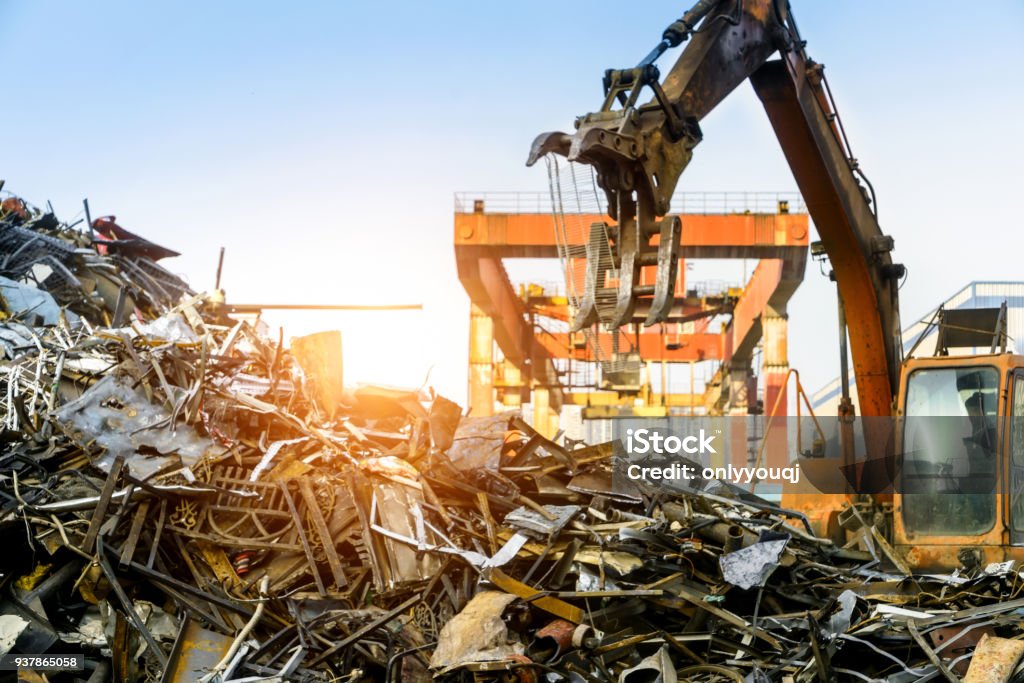 Grab crane works in waste recycling station Scrap Metal Stock Photo