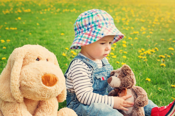 istock sad boy sitting with softtoys outoors 937865714