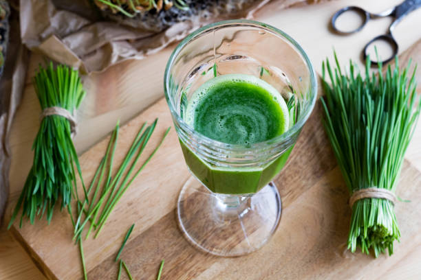 istock A glass of wheatgrass juice with fresh wheatgrass 937865816