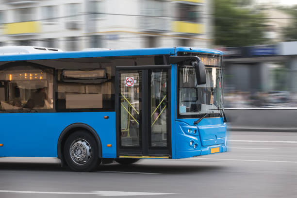 istock bus goes along street 937868202