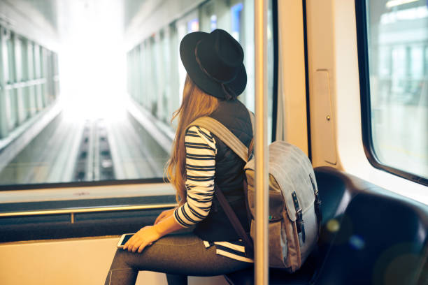 istock Young woman using train during flight connection in airport 937868522