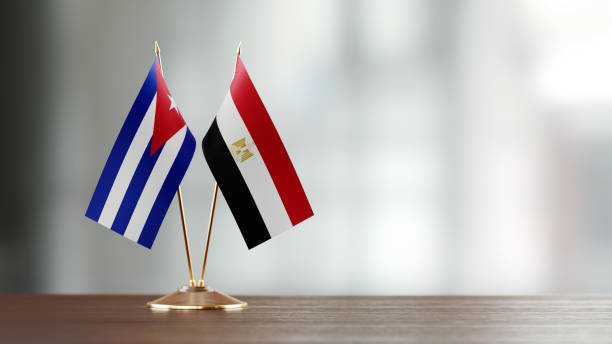 istock Cuban And Egyptian Flag Pair On A Desk Over Defocused Background 937868634
