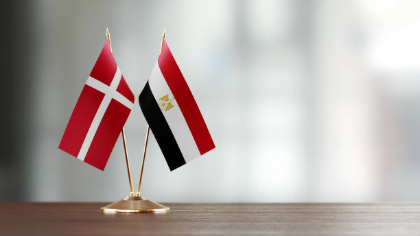 istock Danish And Egyptian Flag Pair On A Desk Over Defocused Background 937868760
