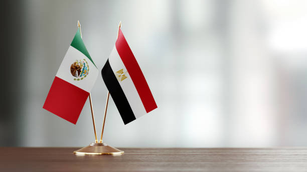 istock Mexican And Egyptian Flag Pair On A Desk Over Defocused Background 937870828