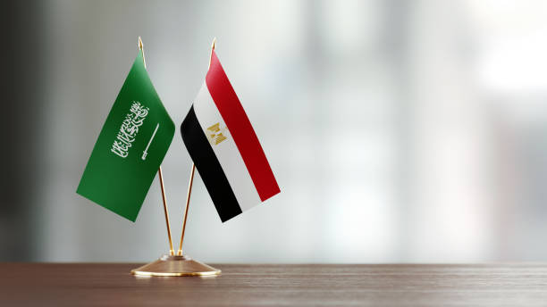 istock Saudi Arabian And Egyptian Flag Pair On A Desk Over Defocused Background 937870896