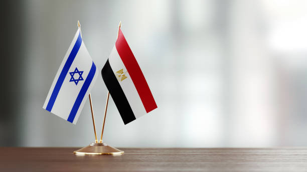 istock Israeli And Egyptian Flag Pair On A Desk Over Defocused Background 937871016