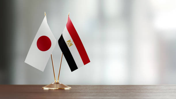 istock Japanese and Egyptian Flag Pair On A Desk Over Defocused Background 937874186
