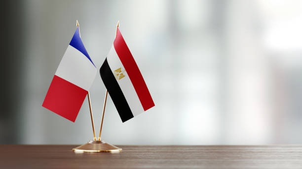 istock French and Egyptian Flag Pair On A Desk Over Defocused Background 937874254