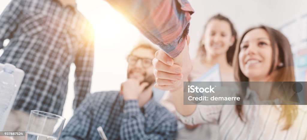 Partnerships and startups: business people shaking hands Young business team meeting in the office and shaking hands: start up, business and cooperation concept Recruitment Stock Photo