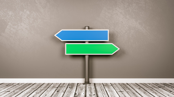 Blue and Green Arrow Shaped Road Sign on Wooden Floor Against Gray Wall with Copy Space 3D Illustration, Choice Concept