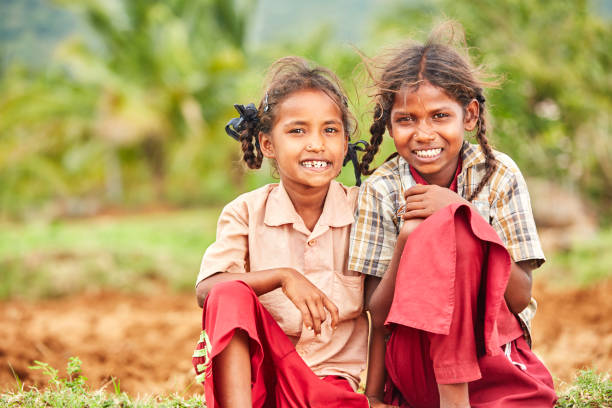 istock Cheerful cute Indian sisters in school uniform 937888004