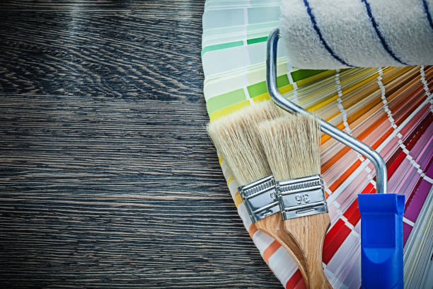 istock Paint brushes roller color pantone fan on wooden board 937888316