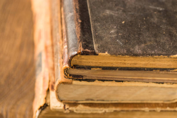 istock Ancient books lie in a pile. Leather bindings, worn covers, yellowed pages. 937888478