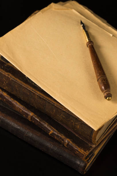 istock A pile of old books in leather bindings set aside for work on the table. 937890594