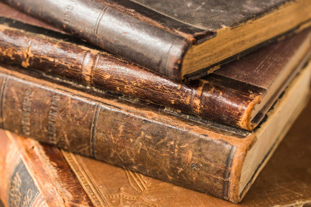 istock Ancient books lie in a pile. Leather bindings, worn covers, yellowed pages. 937890620