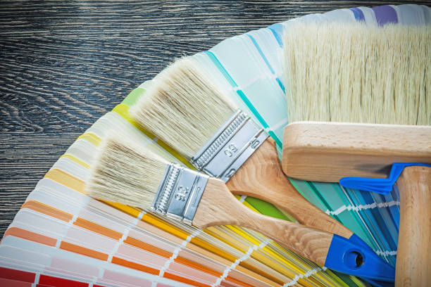 istock Paintbrushes color palette on wooden board 937890956