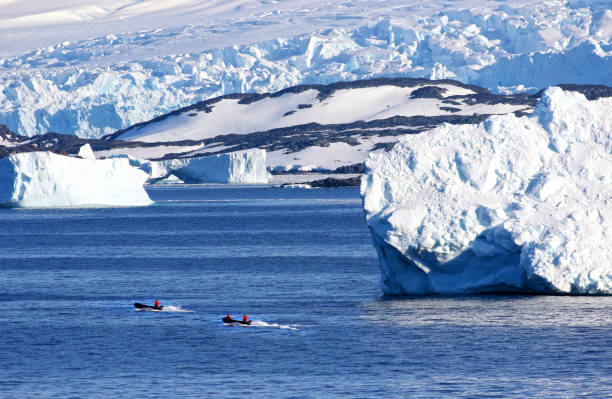 istock Antarctic ocean, Antarctica. Glacier Snow Covered Mountain and Floating Icebergs 937894608