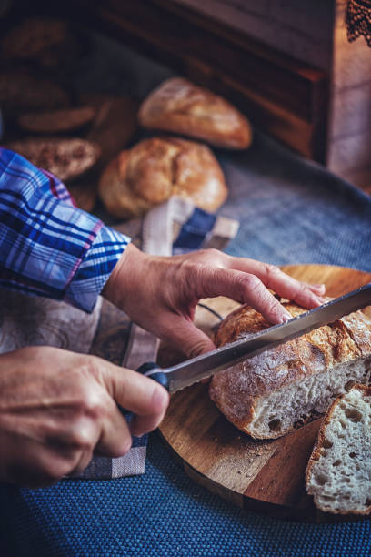 istock Cutting Fresh Homemade Bread 937896386