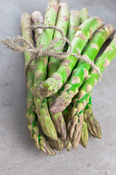 istock raw green asparagus on the wood background 937901948