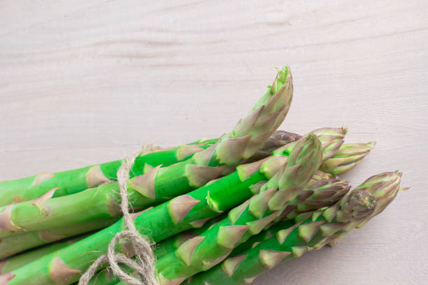 istock raw green asparagus on the wood background 937901966