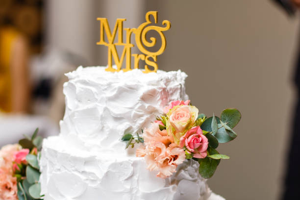 istock a multi level white wedding cake on a silver base and pink flowers on top 937910862