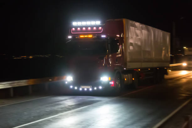 istock truck moves on highway at night 937911290