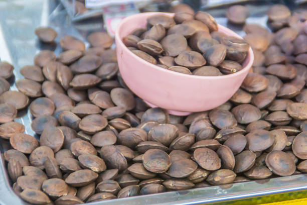 Roasted sacha inchi seeds for sale in the local market, Chiang Rai, Thailand. Plukenetia volubilis, commonly known as sacha inchi, sacha peanut, mountain peanut, Inca nut or Inca-peanut. Roasted sacha inchi seeds for sale in the local market, Chiang Rai, Thailand. Plukenetia volubilis, commonly known as sacha inchi, sacha peanut, mountain peanut, Inca nut or Inca-peanut. plukenetia volubilis sacha inchi sacha peanut mountain peanut stock pictures, royalty-free photos & images