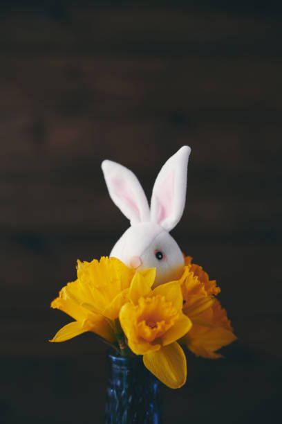 istock Easter background with bouquet of daffodils and cute bunny 937917342