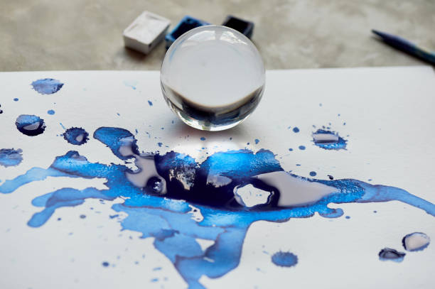 istock glass bowl and reflection in blue ink puddle.Abstraction 937920258
