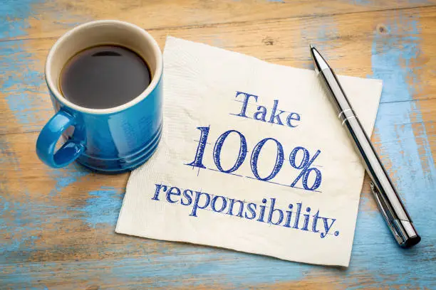 Photo of Take responsibility reminder note on napkin