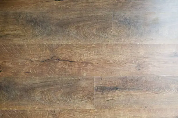 Photo of texture of wooden worm colored parquet floor