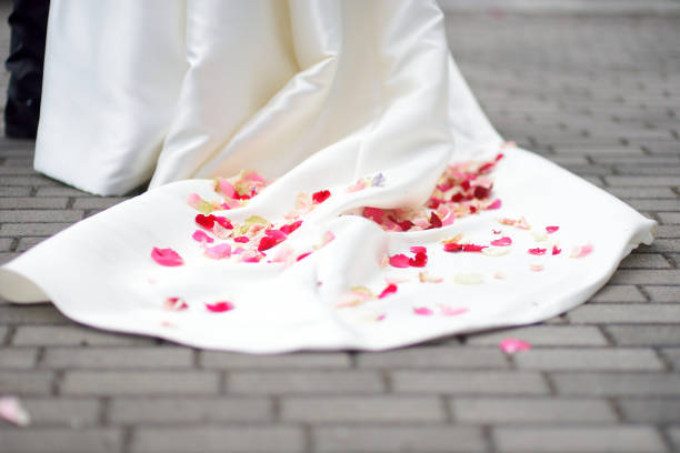 Rose petals on a wedding dress after wedding ceremony
