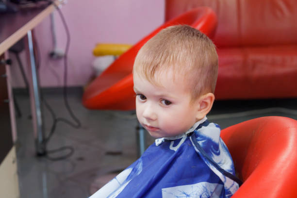istock Cute little boy at the barbershop 937942354