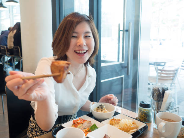 istock Asian woman having lunch 937945382