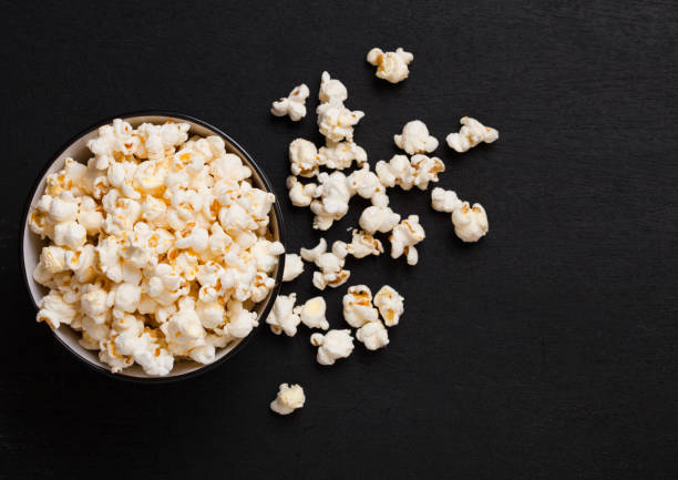 istock Black bowl with fresh salted popcorn on wood 937948968