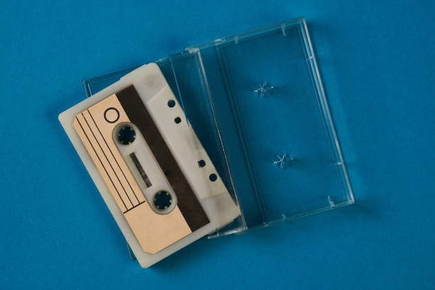 istock Blank cassette tape box with retro cassette on blue background 937949140