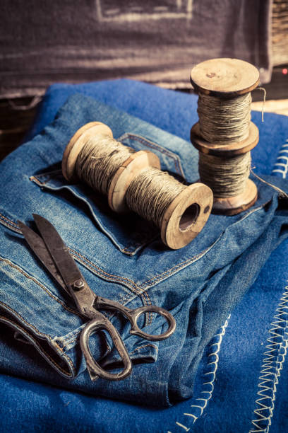 istock Closeup of cloth and needle in a tailor workshop 937953686