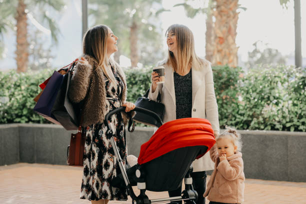 Mother and daughter are walking on the street Mother and daughter are walking on the street baby boutique stock pictures, royalty-free photos & images