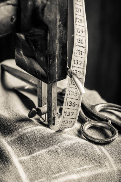 istock Closeup of sewing machine with cloth, scissors and tape 937956808