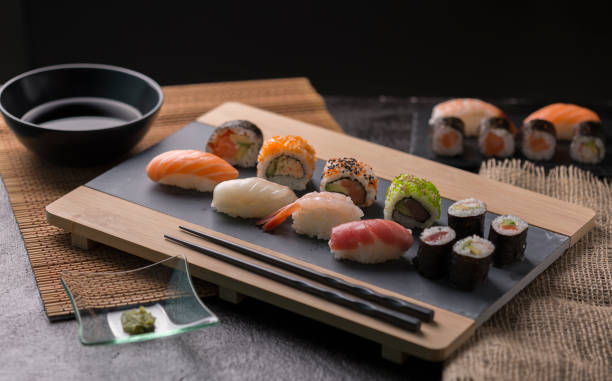 istock Sushi Set sashimi and sushi rolls served on stone slate 937956846