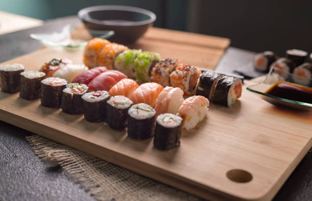istock Sushi Set sashimi and sushi rolls served on stone slate 937956868