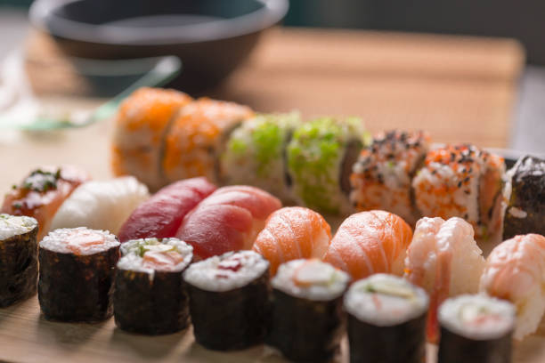 istock Sushi Set sashimi and sushi rolls served on stone slate 937956876