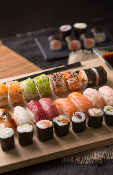 istock Sushi Set sashimi and sushi rolls served on stone slate 937956878
